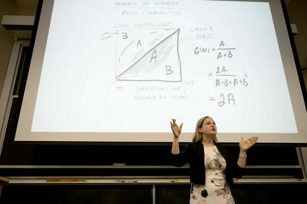 Photo of Professor Eva Dziadula Teaching Her Economics Of Immigration Class